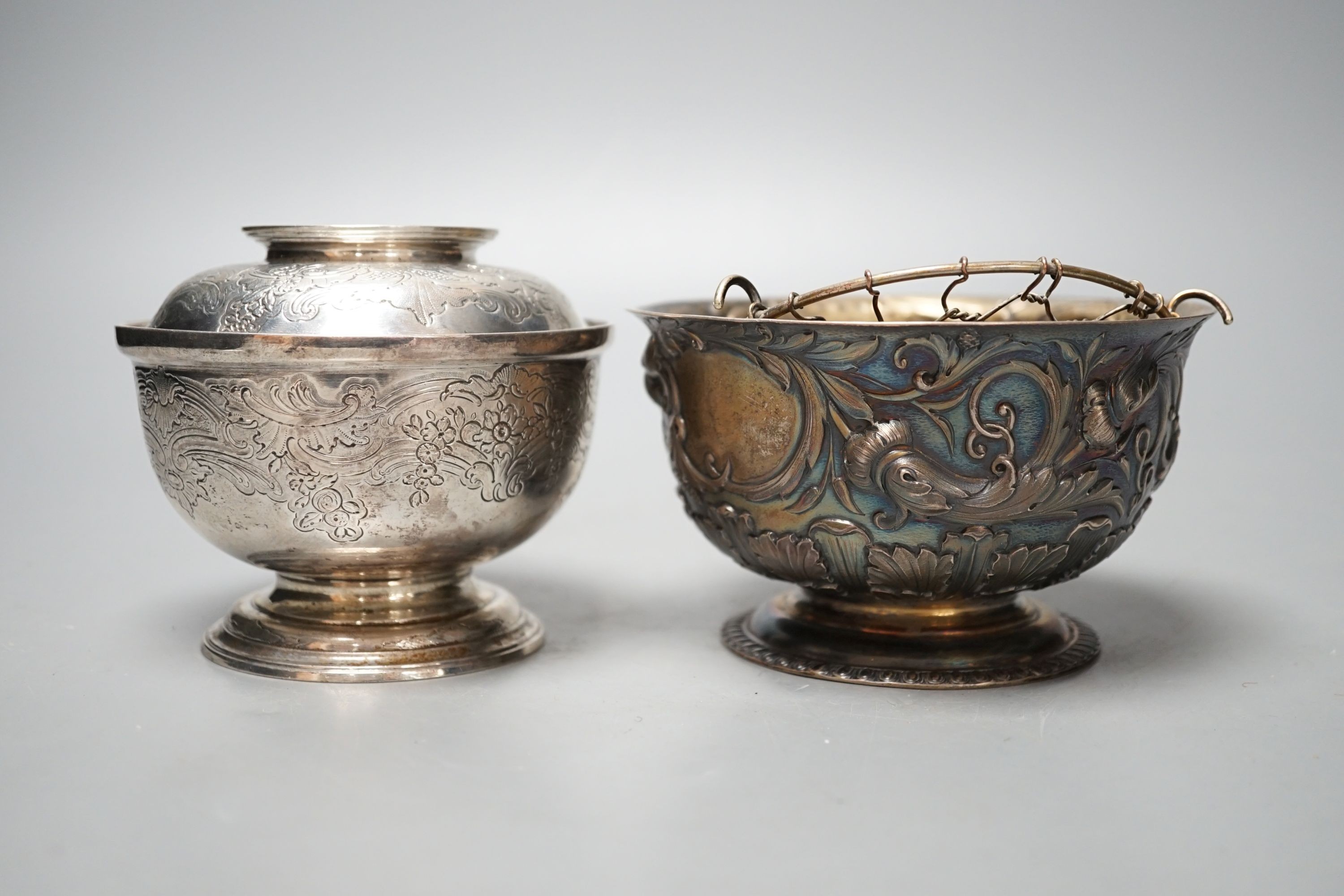 An Edwardian silver bowl, embossed with putto amid scrolls, London, 1902, diameter 13.1cm and a white metal bowl and cover, gross 20.5oz.
